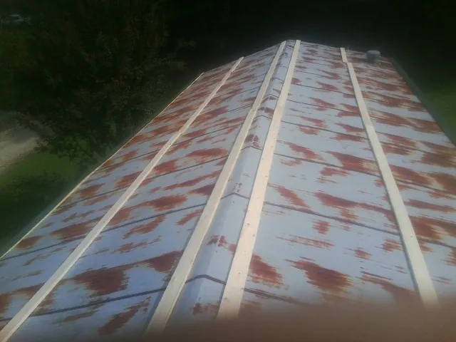 Rusted metal roof panels with new wood purlins before replacement — Storm Damage Roof Repair in Granite Bay by Roofing Brothers