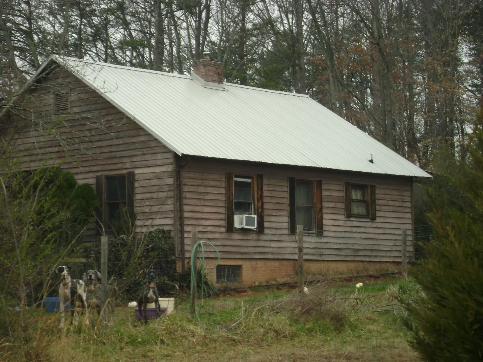 White metal roof on an old wood sided farmhouse, from a Metal Roof Installation job in Granite Bay